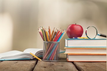 Colorful school supplies on wooden background