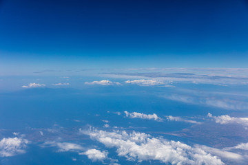 Fototapeta na wymiar Cloudscape background. View out of an airplane window.