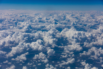 Cloudscape background. View out of an airplane window.