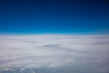 Naklejka na ściany i meble Cloudscape background. View out of an airplane window.