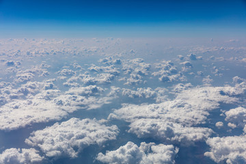 Fototapeta premium Cloudscape background. View out of an airplane window.