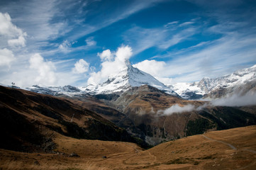 Matterhorn with cloud and snow against blue sky 