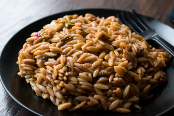 Turkish Style Cooked Orzo Pasta in Black Plate / Pilav or Pilaf.