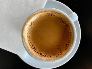Top View of Espresso Foam with White Napkin Copy Space.