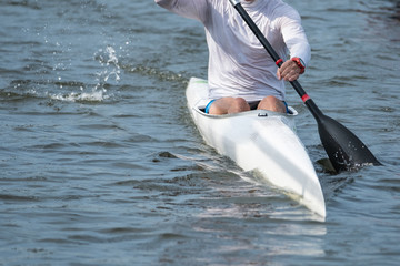 Photo of a part of a kayak with a paddle and a rower. © Valerii