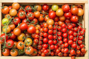 Fresh tomatoes in a wooden box. Top view. 