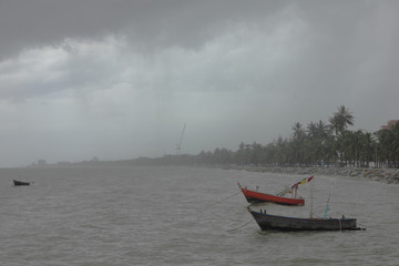 storm batter to the beach with fishing boat.