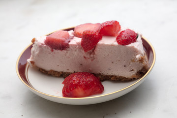 slice of strawberry cheesecake on white background, selective focus