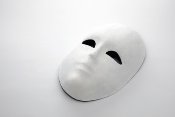 White mask on white background with shadow
