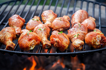 Hot chicken leg on grill with spices and herbs