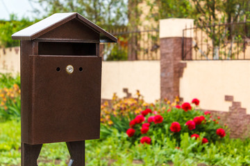 A beautiful mailbox hangs waiting for newspapers, parcels and letters.