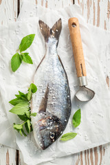 Seasoning freshly caught fish with salt and herbs