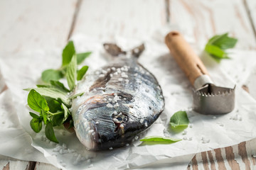 Preparing whole sea bream with lime and mint leaves