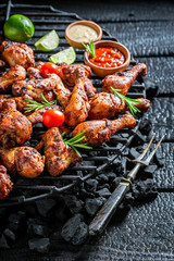 Tasty grilled chicken leg with sauces and lime