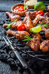 Crispy grilled chicken leg with sauces and lime