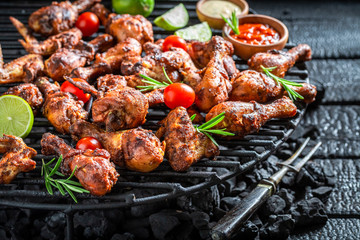 Crispy roasted chicken wings with sauces and lime