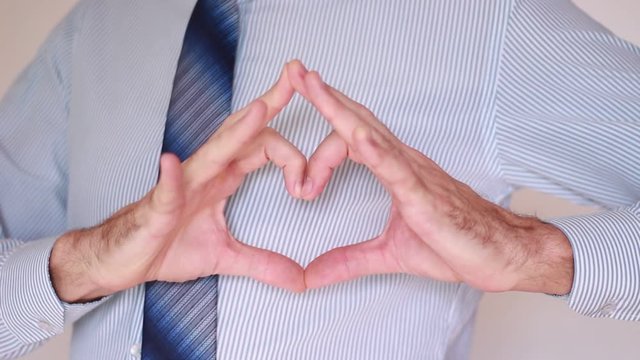 Businessman hands in heart shape sign