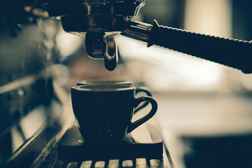 group handle of espresso machine ready to brew coffee, dark tone