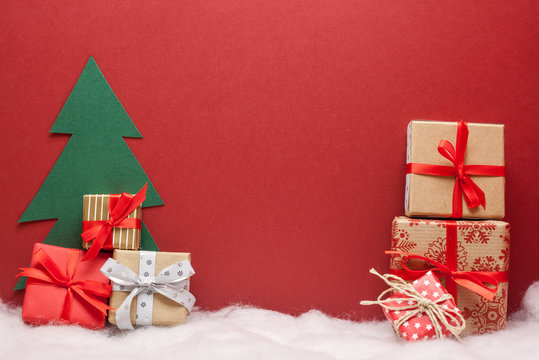 pile of christmas gifts red background with copyspace