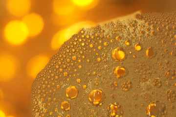Cooking oil, water with oil emulsions and bubbles in the background.