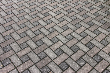 Texture: light street paving slabs of rectangular shape, gray and red.