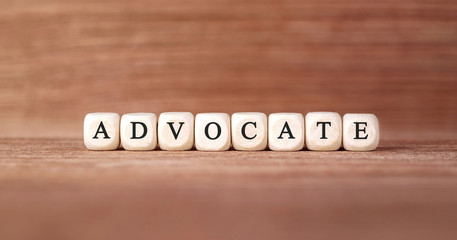 Word ADVOCATE made with wood building blocks
