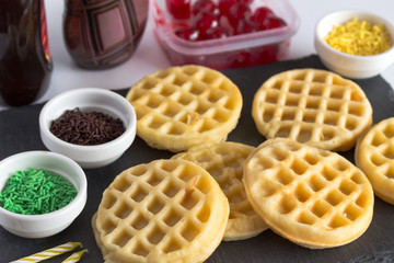 Waffles with sprinkles, sweet decorating accessories  and birthday candles
