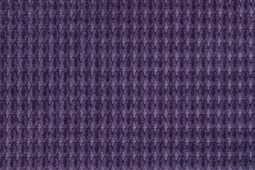 Dark violet background from soft fleecy fabric close up. Texture of textiles macro