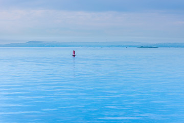 Blue hour - river landscape with buoy