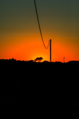 Obraz premium sunset with red sky and black foreground