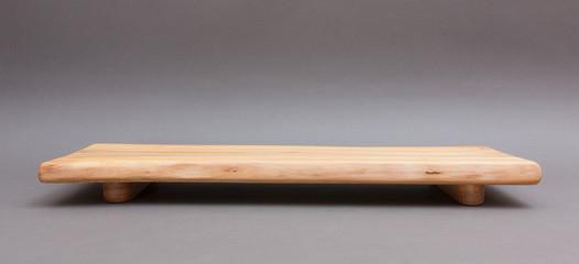 Ecological handmade wooden cutting board on grey background