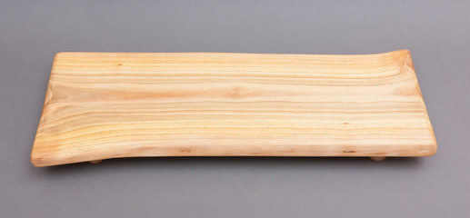 Ecological handmade wooden cutting board on grey background