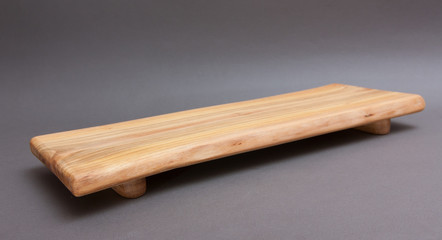 Ecological handmade wooden cutting board on grey background
