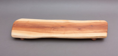 Ecological handmade wooden cutting board on grey background