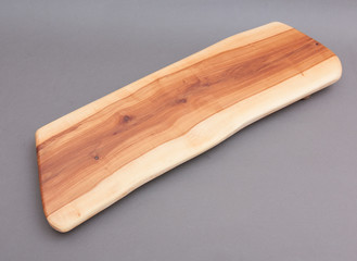 Ecological handmade wooden cutting board on grey background
