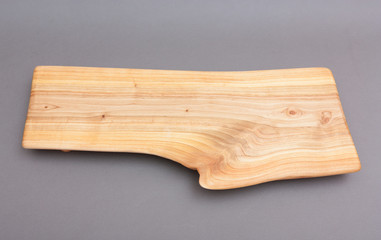 Ecological handmade wooden cutting board on grey background