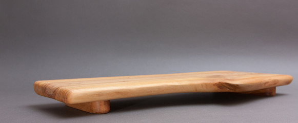 Ecological handmade wooden cutting board on grey background