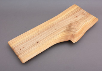 Ecological handmade wooden cutting board on grey background