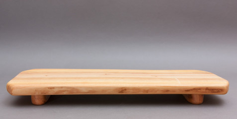 Ecological handmade wooden cutting board on grey background