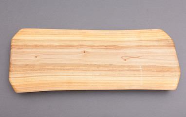 Ecological handmade wooden cutting board on grey background