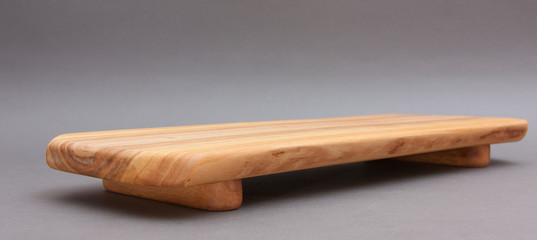 Ecological handmade wooden cutting board on grey background