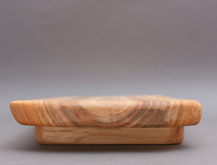 Ecological handmade wooden cutting board on grey background