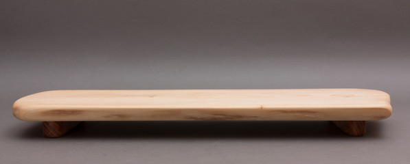 Ecological handmade wooden cutting board on grey background