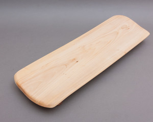Ecological handmade wooden cutting board on grey background