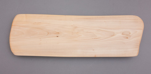 Ecological handmade wooden cutting board on grey background