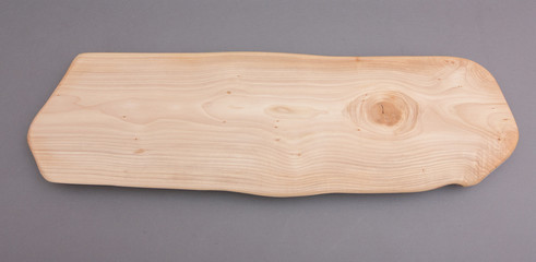 Ecological handmade wooden cutting board on grey background