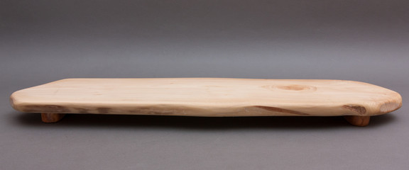 Ecological handmade wooden cutting board on grey background