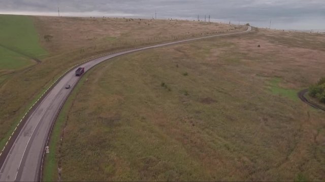 Aerial view of autumn country road with cars. Logistics and transportation concept