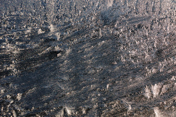 Background of glass with ice fibers. The sun creates fanciful highlights.