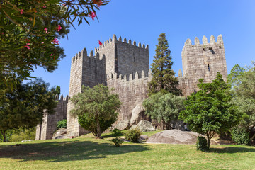 Fototapeta na wymiar Castelo de Guimaraes Castle. Most famous castle in Portugal. Birth place of the first Portuguese King and the Portuguese nation. Guimaraes, Portugal.